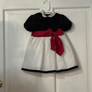 White black dressed with red bow.